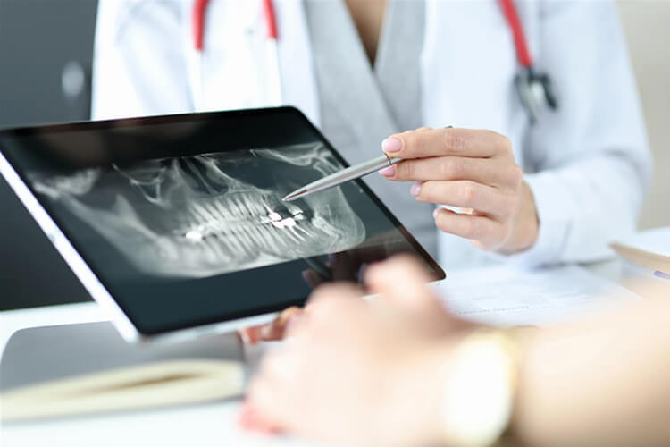 Dentist reviewing a digital dental X-ray on a tablet during a preventive dentistry consultation. Top-Rated Dental Services in Burlington, NJ
